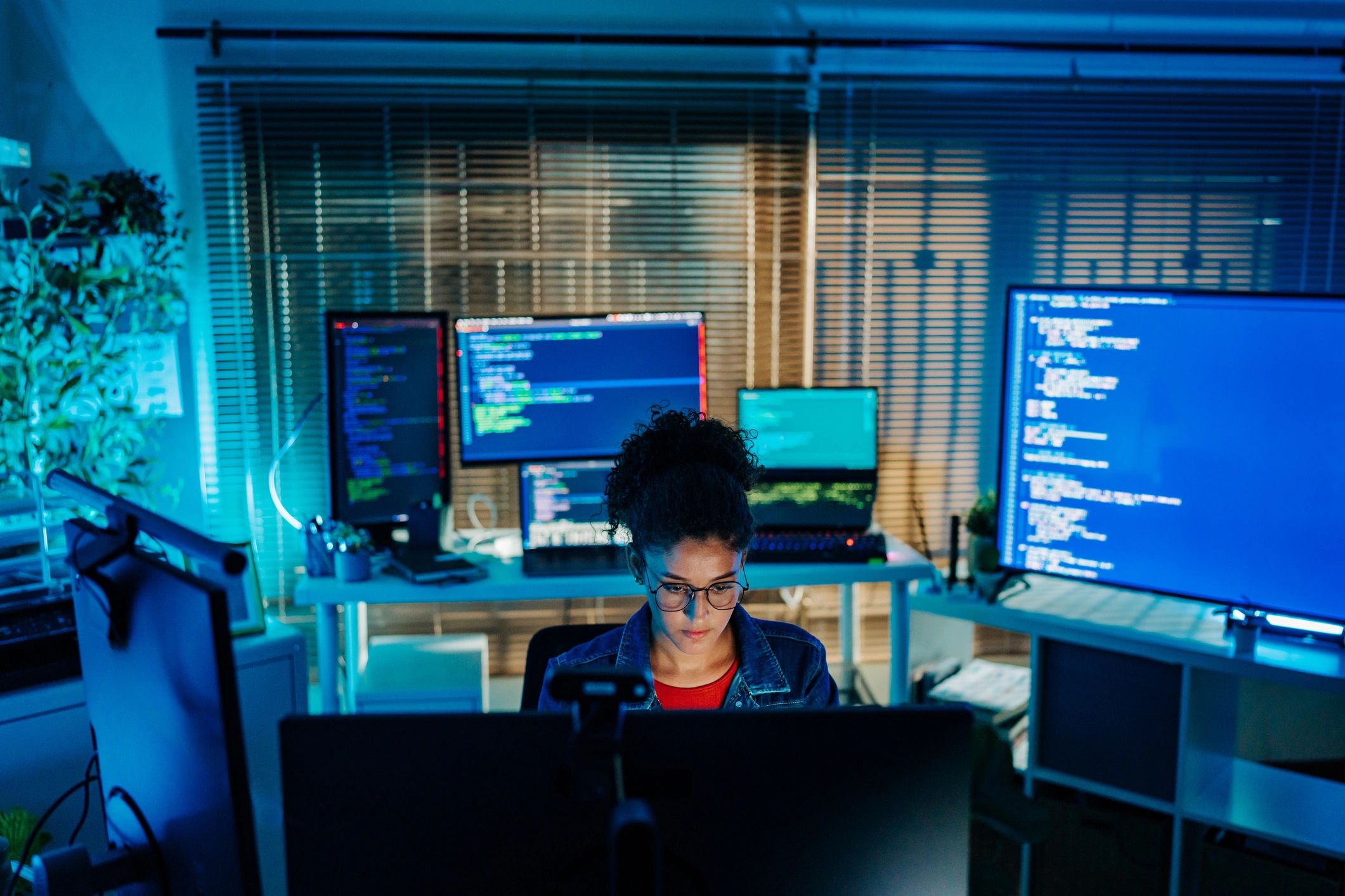 Professional working with secure software at a multi-monitor workstation