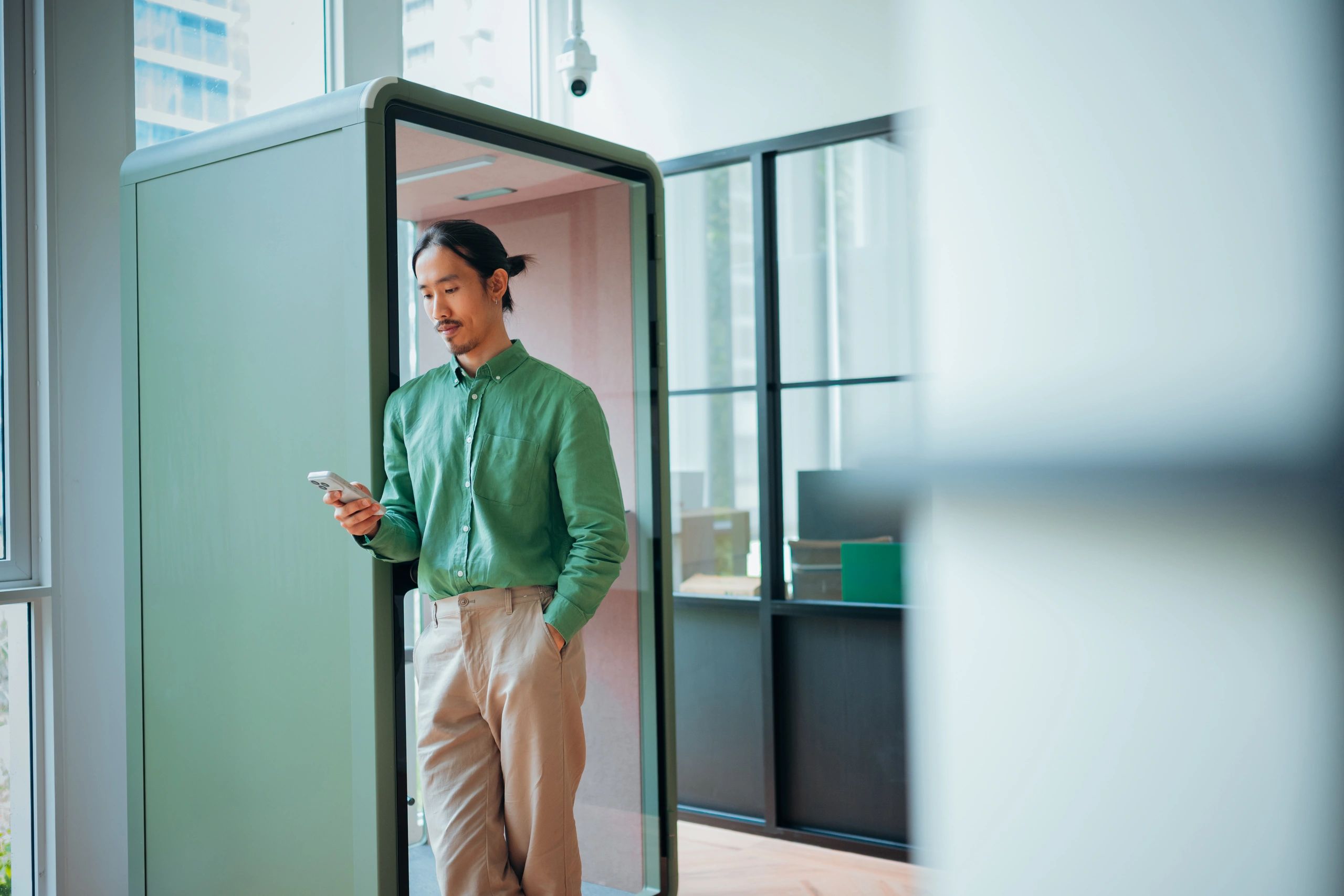 Business professional using a smartphone in a modern technology workspace